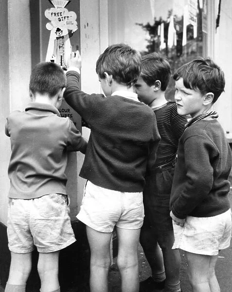 Boys using bubble gum machine, Balham, SW London