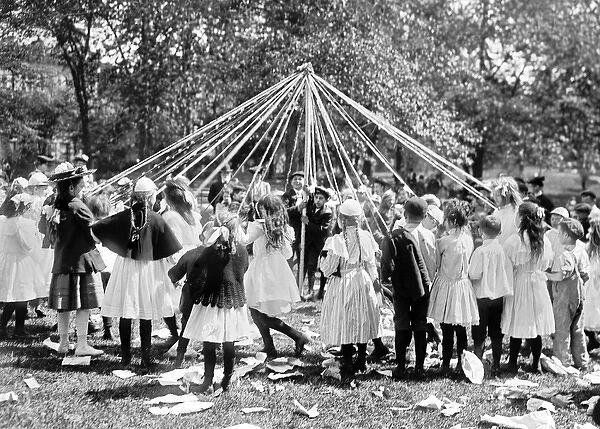 Children dancing around a May pole, Central Park, New York C