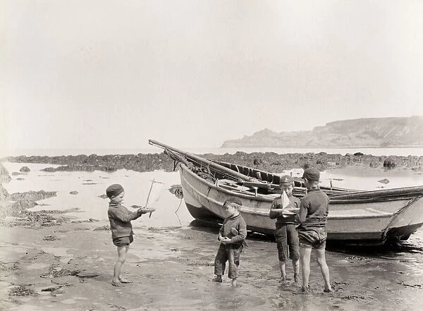 Children playing on the beach aat Runswick Bay Yorkshire