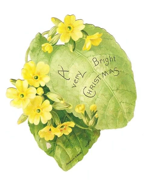 Christmas card in the shape of a green leaf with primroses