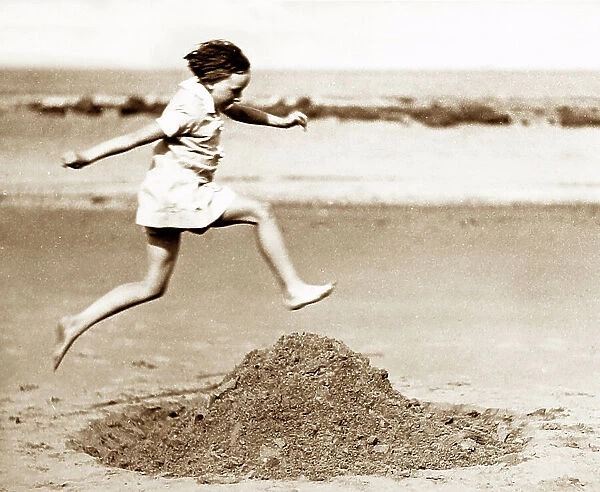Girl playing on the beach, early 1900s