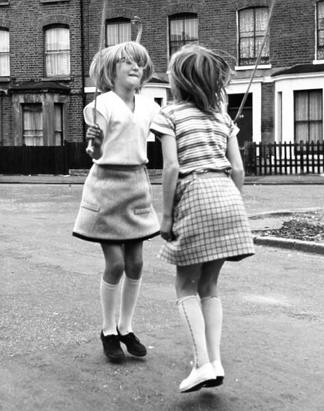 Two girls skipping on a Balham street, SW London