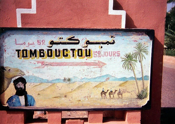 A hand-painted sign showing the time it would take to reach Timbuktu in Mali (52 days