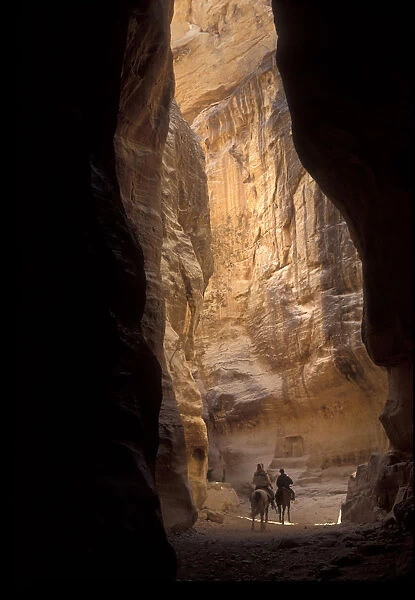 Horse riders in Petra ravine, Jordan