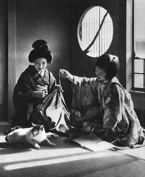 Japan - Woman and Young Girl Play with a Kitten