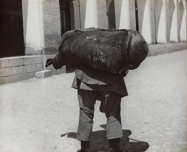 Man carrying a heavy weight