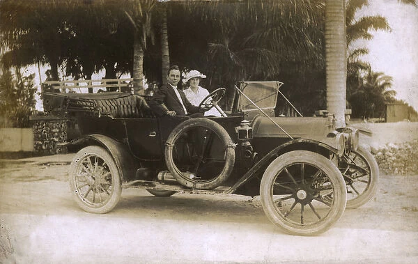 Man and woman in a touring car, USA