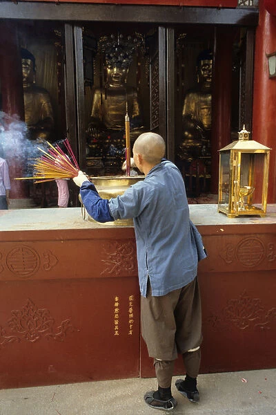 Monk and incense, Temple of the Six Banyan Trees