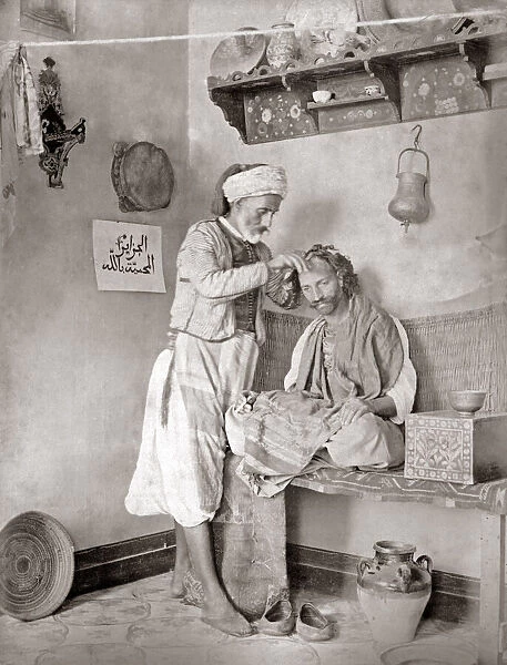 North Africa, barber at work, circa 1880s. Date: circa 1880s