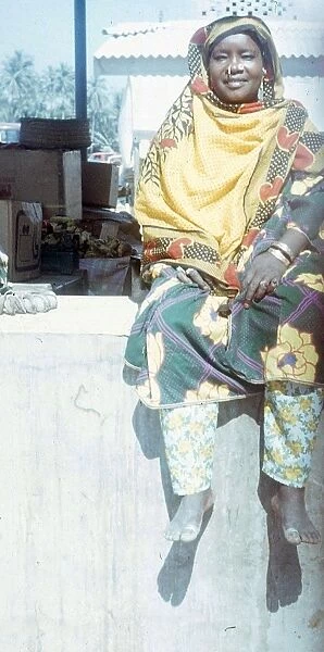 Omani market woman sitting on the wall