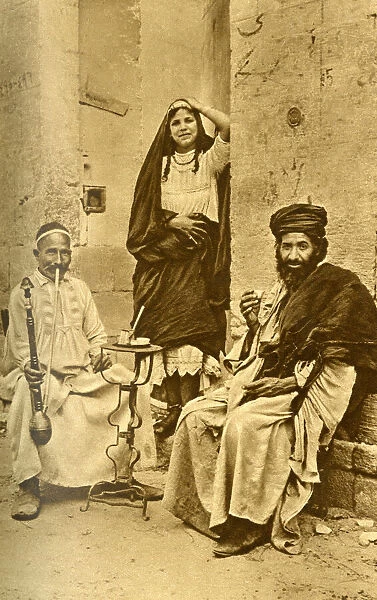 Rich man, dancing woman and beggar, Cairo, Egypt