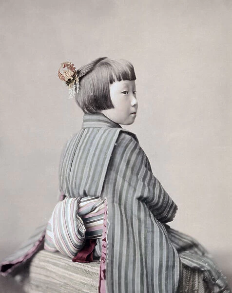 Young girl in Kimino showing her obi sash, Japan, c, 1890