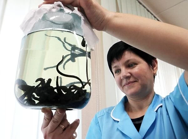 Nurse with a jar of medicinal leeches C018  /  2317