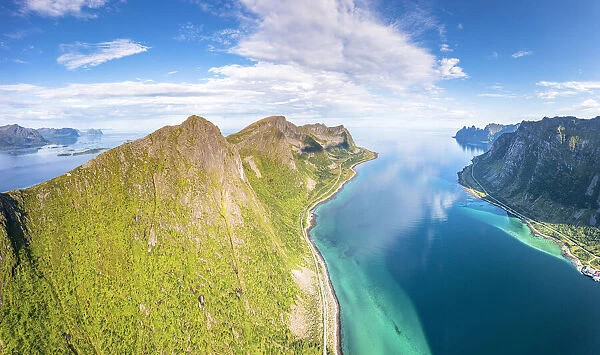 Aerial view of Husfjellet mountain peak overlooking the emerald green water of Steinfjord