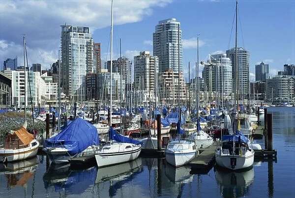 Boats in the marina at False Creek, and the city skyline of Vancouver behind