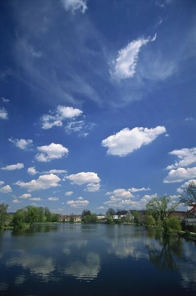 Clouds reflected in a tranquil fishpond in the town of Telc in South Moravia