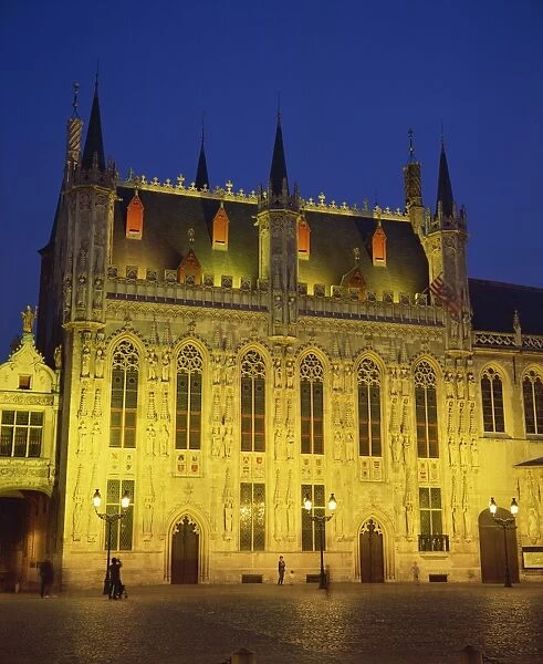 The illuminated facade of the Town Hall in Burg Square in Bruges, at night