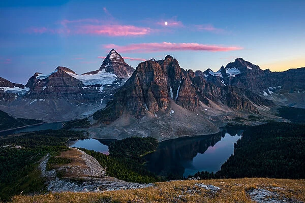 Sunset on top of Nub Peak, looking at Mount Assiniboine and the moon