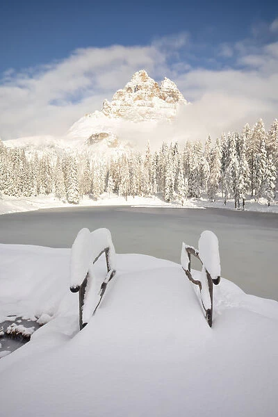 a famous Tre Cime of Lavaredo seen from the Antorno lake in winter time, Dolomiti