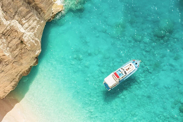 A man relaxing on his yacht docked at Navagio beach, Zakynthos, Ionian Islands, Greece