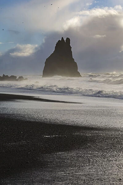 Rock emerging from the ocean at the beach of Reynisfjara, Vik, Sudurland, Iceland, Europe
