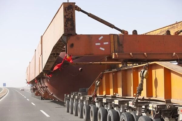 A huge load trundles on a low loader across Inner mongolia in china