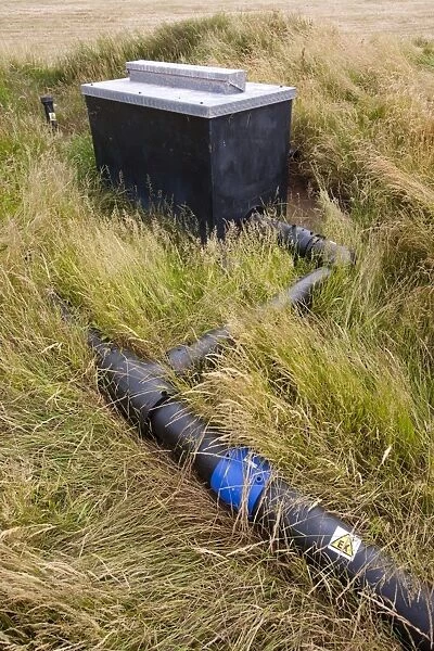 An old rubbish tip on Walney Island in Cumbria where the methane escaping from the decomposing rubbish is being captured and burnt to prevent this highly potent greenhouse gas from escaping into the atmosphere. Methane is over 20 times more