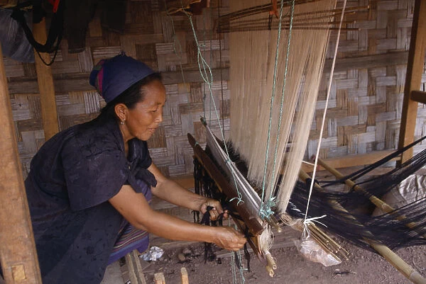 20031598. LAOS Craft Hmong woman weaving on hand loom