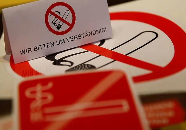 No smoking signs are seen on a table in a sign shop in Vienna