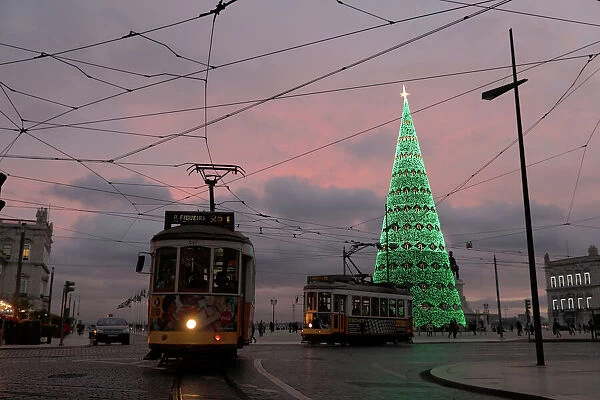 Trams are seen near a Christmas tree at Comercio square in Lisbon