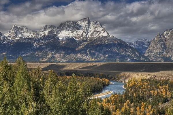 View of mountain range and forested river valley, Snake River, Grand Teton N. P. Wyoming, U. S. A. October