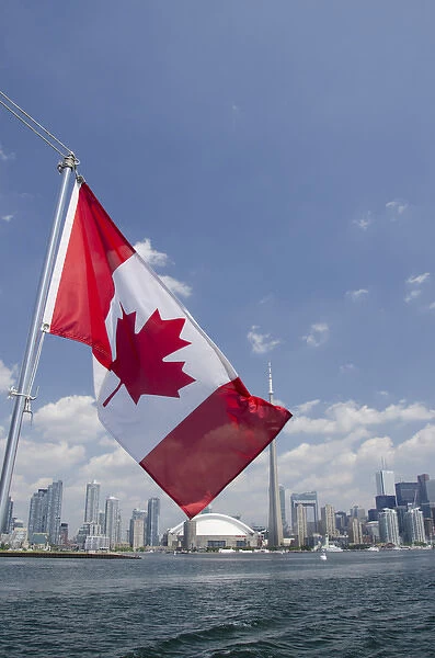 Canada, Ontario, Toronto. Lake Ontario city skyline view with CN Tower & Canadian flag
