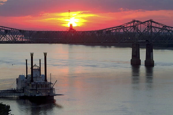Sunset with steamboat under the Natchez-Vidalia Bridges spanning the Mississippi