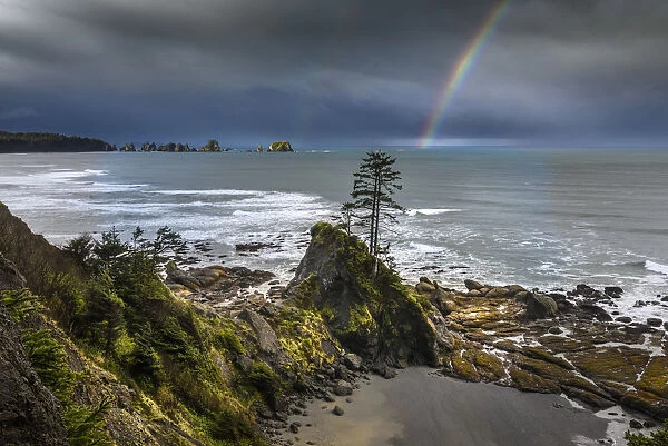 USA, Washington State, Olympic Peninsula. Shi Shi Beach, Rainbow over Point of the Arches