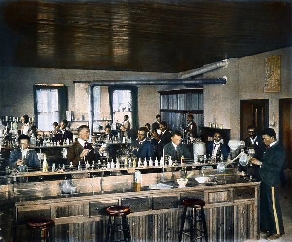 (1864-1943). American botanist, chemist, and educator. Carver (second from right) teaching in a chemistry laboratory at Tuskegee Institute, Alabama, c1906
