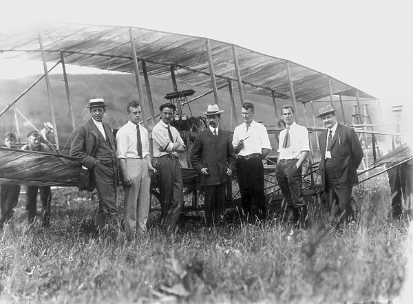 (1878-1930). American inventor and aviator. Curtiss (third from left) with his June Bug, 1910