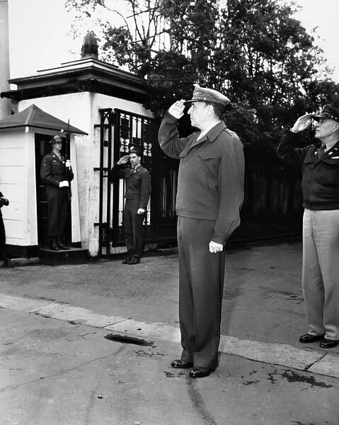 (1880-1964). American army officer. MacArthur salutes a band playing the National Anthem outside of his residence in Tokyo, Japan, after World War II, 1946