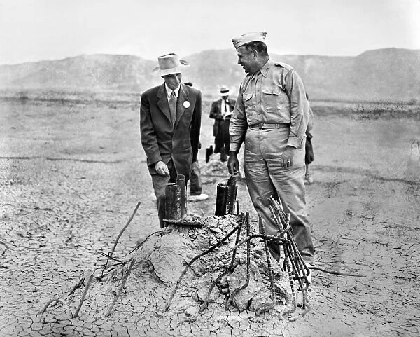 (1904-1967). American physicist. Oppenheimer (left) as scientific director of the Manhattan Project during World War II, inspecting an atomic test site in the desert at Los Alamos, New Mexico, with Major General Leslie Groves (1896-1970), the projects military director