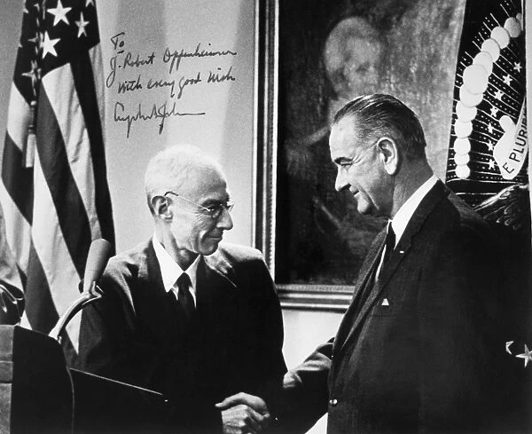 (1904-1967). American physicist. Oppenheimer shaking hands with President Lyndon Johnson at a ceremony presenting Oppenheimer with the Enrico Fermi Award on 2 December 1963. Photograph signed by President Johnson