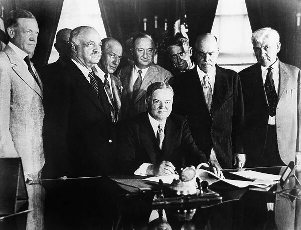 31st President of the United States. Hoover signing the Agricultural Marketing Act in the Oval Office of the White House, Washington, D. C. 15 June 1929. Standing (left to right): Senator Charles McNary, Vice President Charles Curtis, and Representatives David Kincheloe, Fred S. Purnell, Nicholas Longworth, and Gilbert Haugen