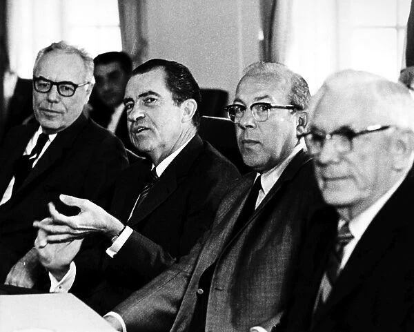 37th President of the United States. President Nixon (second from left) meeting with members of the National Commission on Productivity: Edward Carter (left of Nixon) and George Shultz. Photographed 1970