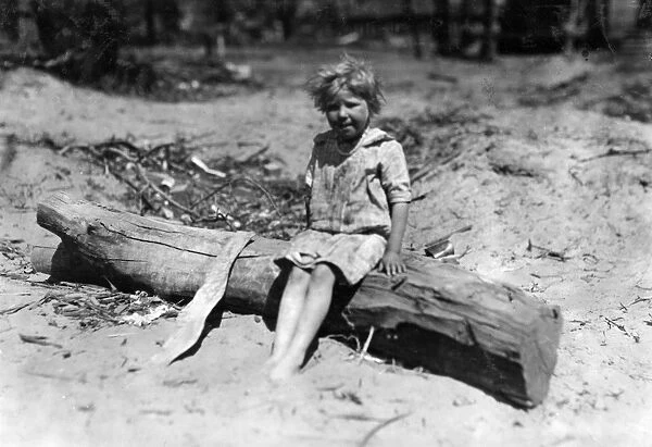 ABANDONED CHILD, 1917. An abandoned child sitting on drift wood, Oklahoma City, Oklahoma