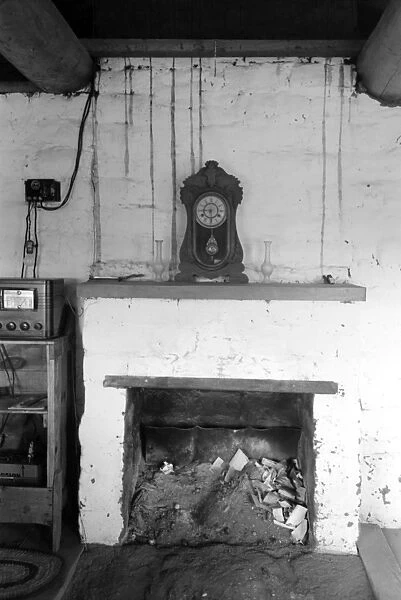 ADOBE HOUSE, 1940. A fireplace in an adobe house in Pie Town, New Mexico