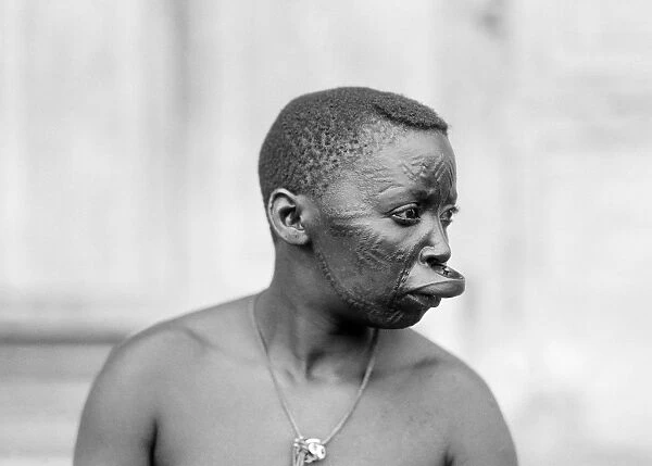 AFRICA: NATIVE WOMAN, 1936. Woman with patterned face and extended upper lip in Dar-es-Salem