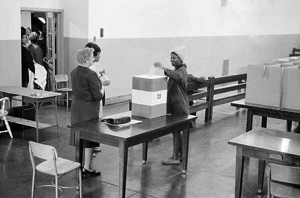 An African American voter casting her vote at a polling station at Cardozo High School, Washington, D. C. 3 November 1964. Photographed by Marion Trikosko