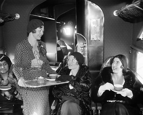 AIRLINE TRAVEL, 1931. Airline hostess Wanda Wood serving tea aboard an Eastern