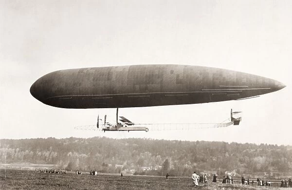 AIRSHIP. An airship flying over an airfield. Early 20th century photograph