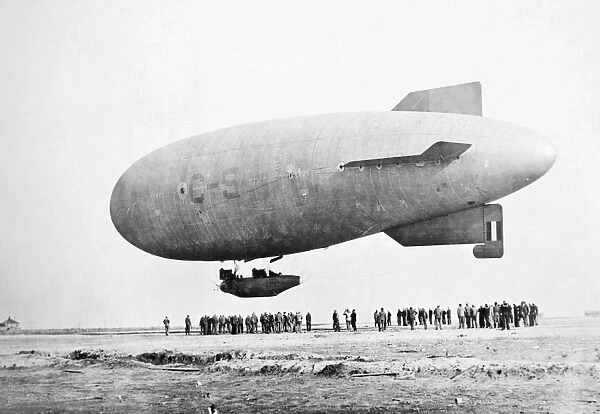 AIRSHIP. An airship flying over an airfield