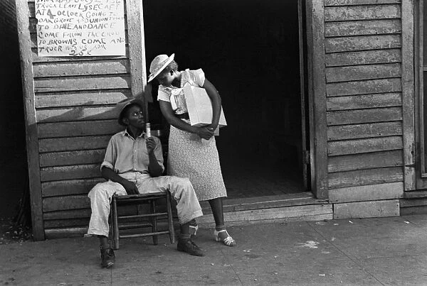 ALABAMA: COUPLE, 1936. A well-dressed African American woman holding a package