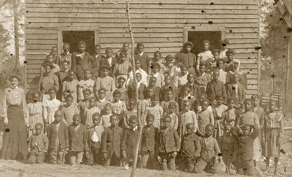 ALABAMA: SCHOOLHOUSE, c1920. A teacher and African American students in front of a schoolhouse